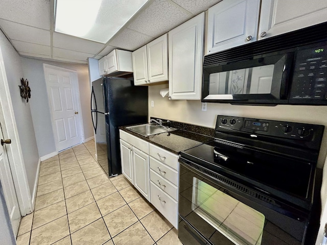 1905 S Ocean Blvd Unit 922-924, Myrtle Beach, SC 29577 - kitchen with black appliances, white cabinets, light tile patterned flooring, dark countertops, and a drop ceiling