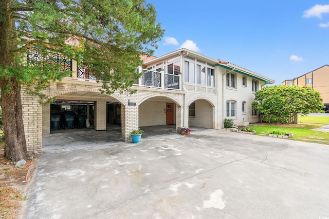 807 N Waccamaw Dr, Murrells Inlet, SC 29576 - view of front of property with a balcony, brick siding, and driveway