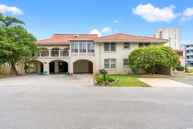 807 N Waccamaw Dr, Murrells Inlet, SC 29576 - view of front of home with a carport, a tiled roof, concrete driveway, a balcony, and brick siding