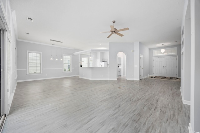 9831 Winchester Ct, Murrells Inlet, SC 29576 - unfurnished living room with a ceiling fan, light wood-style floors, and arched walkways