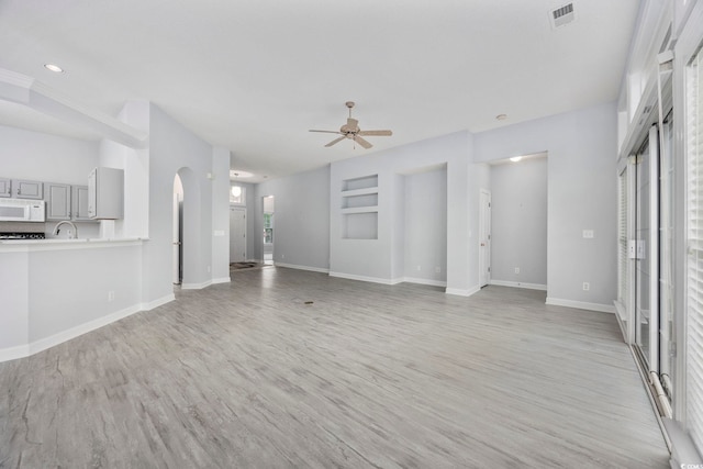 9831 Winchester Ct, Murrells Inlet, SC 29576 - unfurnished living room with light wood-style flooring and a ceiling fan