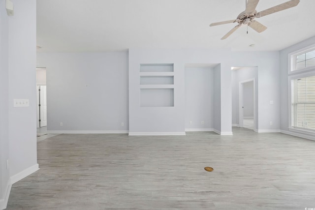 9831 Winchester Ct, Murrells Inlet, SC 29576 - spare room featuring built in features, light wood-style flooring, and ceiling fan