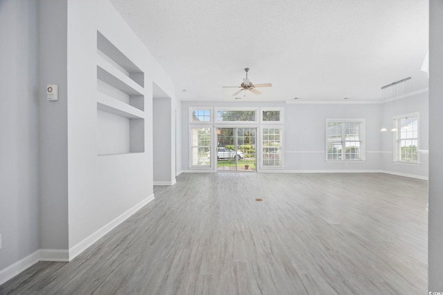 9831 Winchester Ct, Murrells Inlet, SC 29576 - unfurnished living room featuring ceiling fan, wood finished floors, built in shelves, and ornamental molding