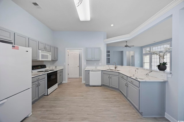 9831 Winchester Ct, Murrells Inlet, SC 29576 - kitchen featuring white appliances, gray cabinetry, a peninsula, light countertops, and light wood-style flooring