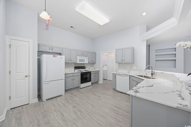 9831 Winchester Ct, Murrells Inlet, SC 29576 - kitchen with white appliances, gray cabinets, light wood-type flooring, hanging light fixtures, and light stone counters