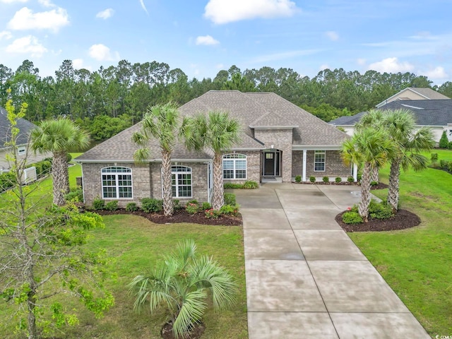 2204 Woodstork Dr, Conway, SC 29526 - french country home with a front yard, a shingled roof, and brick siding