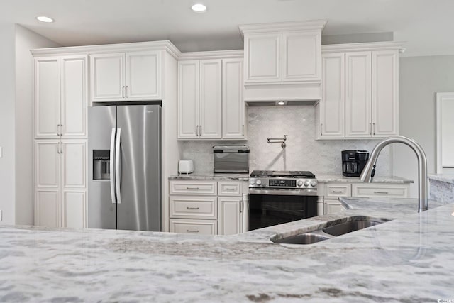 2204 Woodstork Dr, Conway, SC 29526 - kitchen with appliances with stainless steel finishes, light stone counters, tasteful backsplash, white cabinetry, and recessed lighting