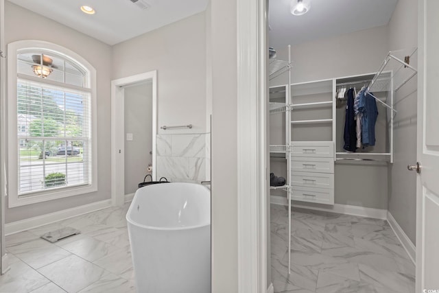 2204 Woodstork Dr, Conway, SC 29526 - bathroom with marble finish floors, a freestanding tub, a spacious closet, baseboards, and recessed lighting