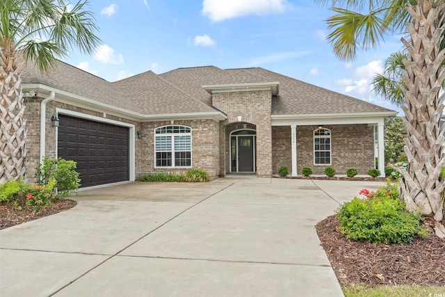 2204 Woodstork Dr, Conway, SC 29526 - french country inspired facade with concrete driveway, a shingled roof, brick siding, and a garage