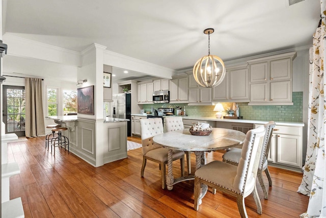 2170 Deerfield Ave, Surfside Beach, SC 29575 - dining room with a chandelier, light wood finished floors, ornamental molding, and recessed lighting