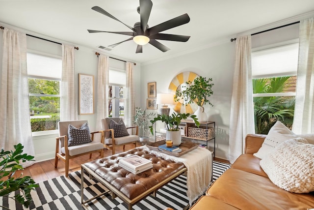 2170 Deerfield Ave, Surfside Beach, SC 29575 - living room featuring ornamental molding, plenty of natural light, wood finished floors, and a ceiling fan
