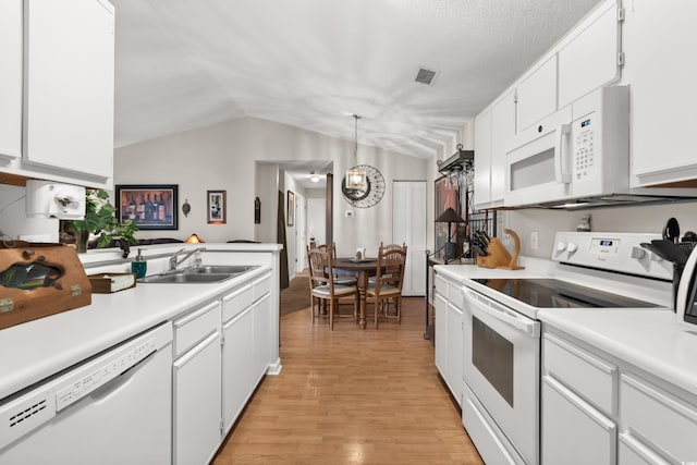 193 Charter Dr Unit E7, Longs, SC 29568 - kitchen with white appliances, a sink, lofted ceiling, light countertops, and light wood finished floors
