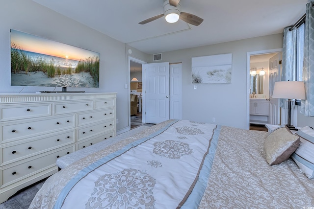bedroom with ensuite bath and a ceiling fan