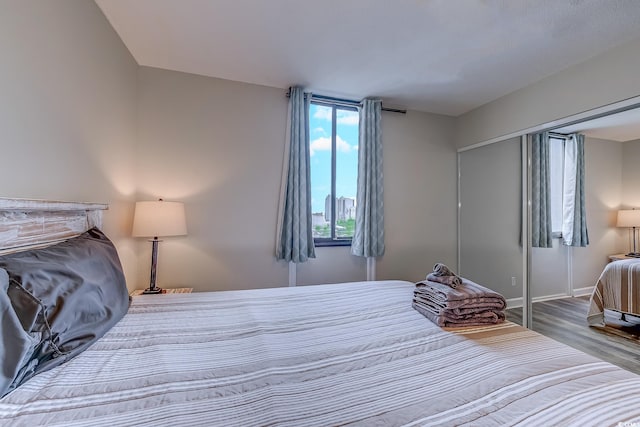 bedroom featuring wood finished floors and baseboards