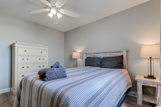 bedroom featuring wood finished floors, baseboards, and ceiling fan