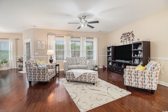 living room featuring wood-type flooring, a ceiling fan, and baseboards