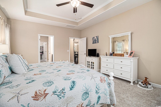 carpeted bedroom featuring crown molding, a ceiling fan, and a tray ceiling