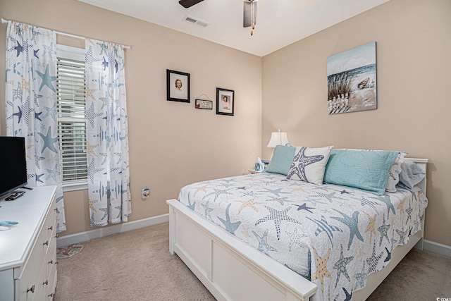 bedroom featuring light carpet, baseboards, and ceiling fan