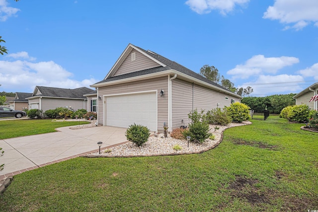 view of home's exterior with a yard, driveway, and an attached garage