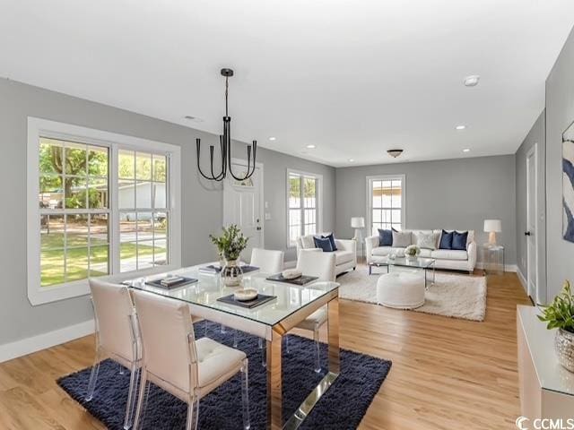 23 Gabe Pl, Pawleys Island, SC 29585 - dining area featuring baseboards, light wood-style floors, recessed lighting, and a chandelier