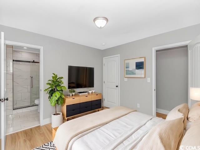 23 Gabe Pl, Pawleys Island, SC 29585 - bedroom featuring ensuite bathroom, baseboards, and wood finished floors