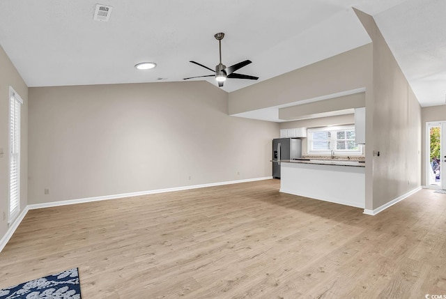 4339 Baldwin Ave Unit 4339, Little River, SC 29566 - unfurnished living room featuring ceiling fan, baseboards, light wood finished floors, and lofted ceiling