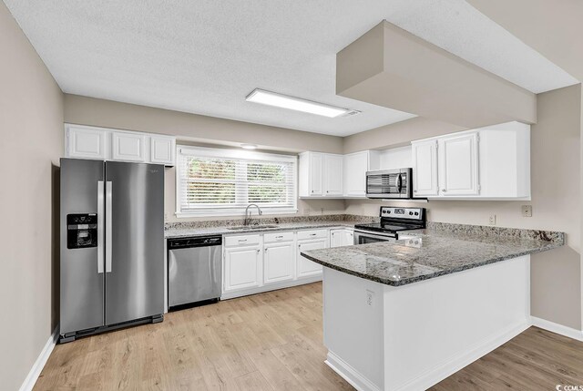 4339 Baldwin Ave Unit 4339, Little River, SC 29566 - kitchen featuring appliances with stainless steel finishes, stone countertops, a sink, and white cabinets