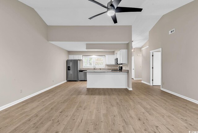 4339 Baldwin Ave Unit 4339, Little River, SC 29566 - kitchen featuring appliances with stainless steel finishes, open floor plan, vaulted ceiling, white cabinets, and a ceiling fan