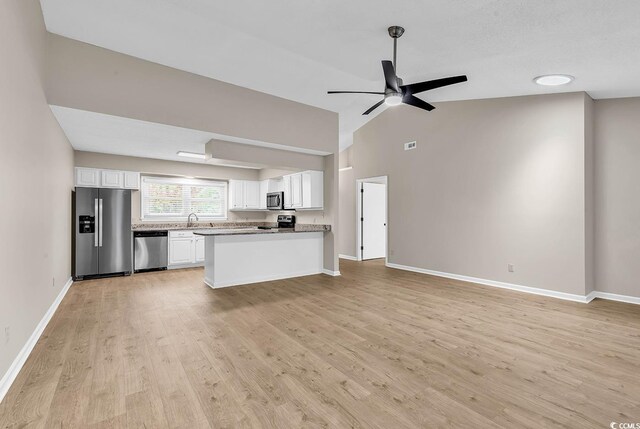 4339 Baldwin Ave Unit 4339, Little River, SC 29566 - kitchen featuring stainless steel appliances, a sink, white cabinetry, light wood-type flooring, and open floor plan