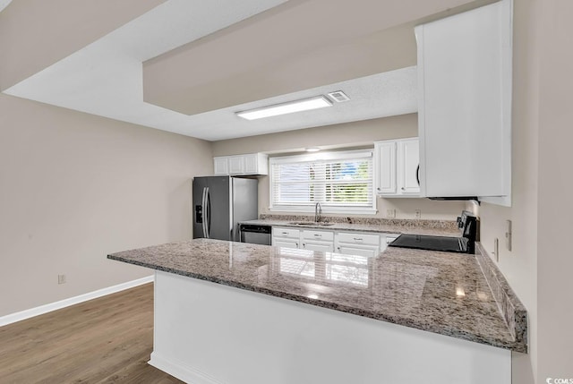 4339 Baldwin Ave Unit 4339, Little River, SC 29566 - kitchen featuring stainless steel appliances, a sink, a peninsula, and light stone countertops