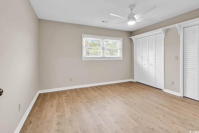 4339 Baldwin Ave Unit 4339, Little River, SC 29566 - unfurnished bedroom with wood finished floors, baseboards, ceiling fan, and multiple closets