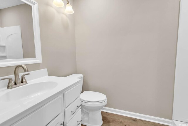 4339 Baldwin Ave Unit 4339, Little River, SC 29566 - bathroom featuring toilet, wood finished floors, vanity, and baseboards