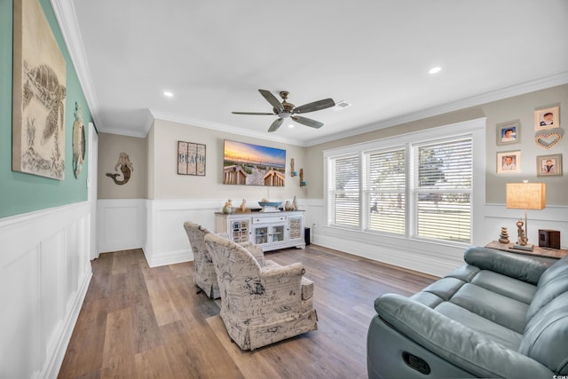 1014 Thomas Ave, North Myrtle Beach, SC 29582 - living room featuring crown molding, ceiling fan, wood finished floors, wainscoting, and recessed lighting