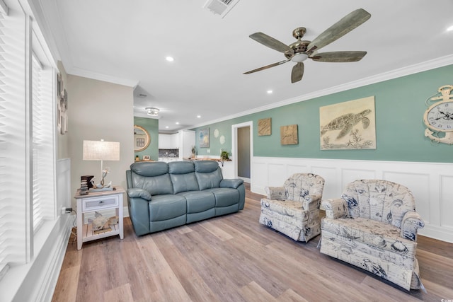 1014 Thomas Ave, North Myrtle Beach, SC 29582 - living room with crown molding, wood finished floors, a ceiling fan, plenty of natural light, and wainscoting