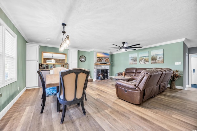 1014 Thomas Ave, North Myrtle Beach, SC 29582 - dining area with a fireplace, ceiling fan, baseboards, ornamental molding, and light wood-type flooring