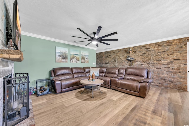 1014 Thomas Ave, North Myrtle Beach, SC 29582 - living area with brick wall, a textured ceiling, wood finished floors, ceiling fan, and a fireplace