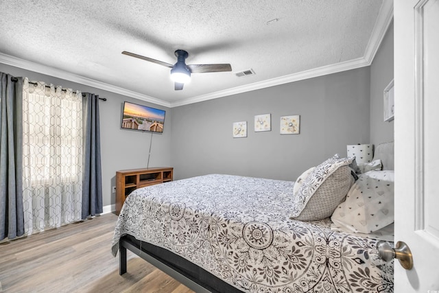 1014 Thomas Ave, North Myrtle Beach, SC 29582 - bedroom featuring wood finished floors, a textured ceiling, crown molding, and ceiling fan