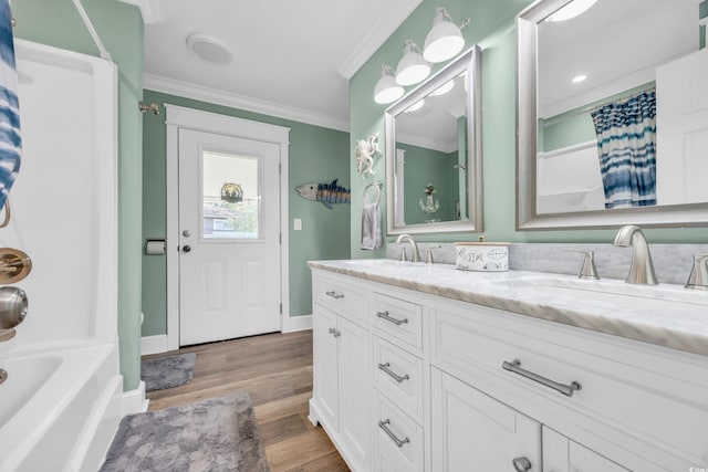 1014 Thomas Ave, North Myrtle Beach, SC 29582 - bathroom with crown molding, wood finished floors, double vanity, baseboards, and shower / tub combo