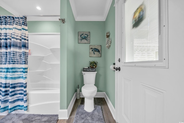 1014 Thomas Ave, North Myrtle Beach, SC 29582 - bathroom with crown molding, wood finished floors, toilet, baseboards, and shower / bath combo