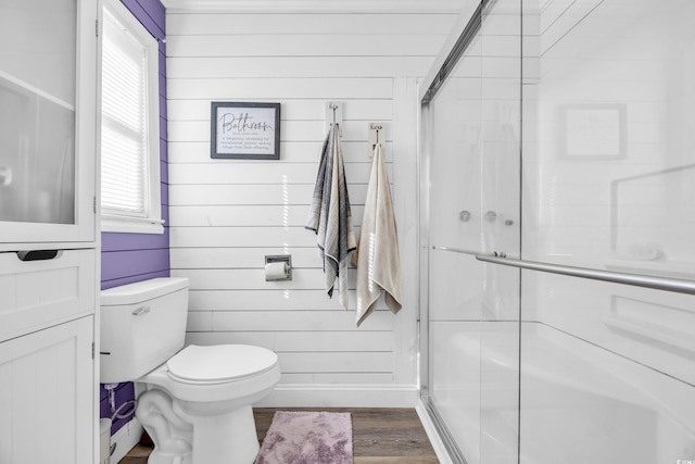 1014 Thomas Ave, North Myrtle Beach, SC 29582 - full bathroom featuring a stall shower, wood finished floors, toilet, wood walls, and baseboards