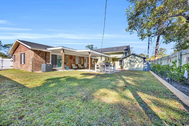 1014 Thomas Ave, North Myrtle Beach, SC 29582 - back of house with central AC unit, a patio area, brick siding, and an outbuilding