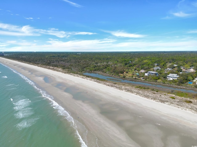 aerial view of a heavily wooded area and extended coastline
