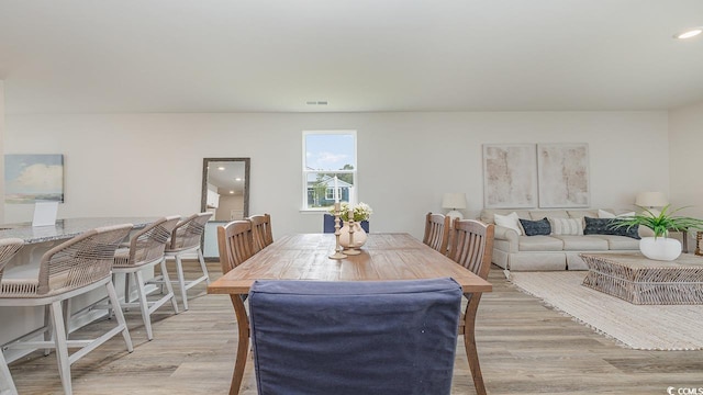 dining area with light wood-style floors and recessed lighting