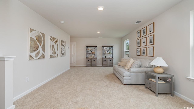 sitting room with light colored carpet, baseboards, and recessed lighting
