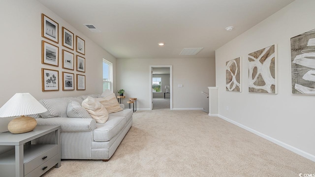 living area featuring light colored carpet, baseboards, and recessed lighting