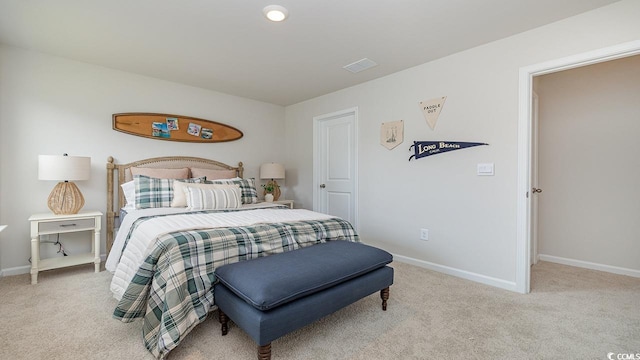 bedroom featuring light colored carpet and baseboards