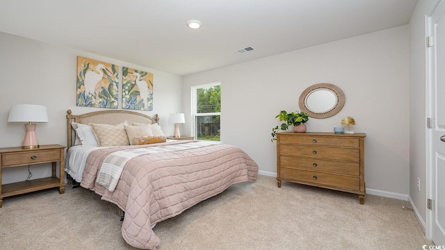 bedroom with light carpet and baseboards