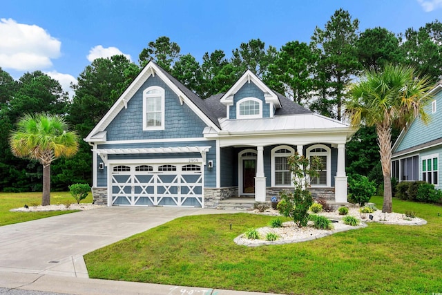 2909 Moss Bridge Ln, Myrtle Beach, SC 29579 - craftsman-style home featuring covered porch, stone siding, a front lawn, driveway, and metal roof