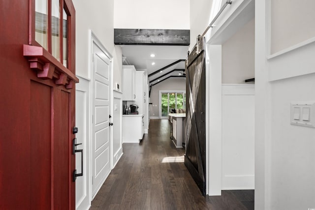 2909 Moss Bridge Ln, Myrtle Beach, SC 29579 - entrance foyer with a barn door, dark wood-type flooring, lofted ceiling, and recessed lighting
