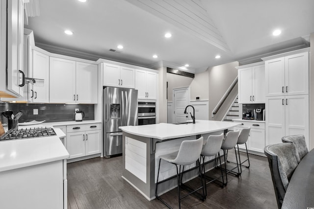 2909 Moss Bridge Ln, Myrtle Beach, SC 29579 - kitchen with appliances with stainless steel finishes, a sink, decorative backsplash, recessed lighting, and a kitchen bar